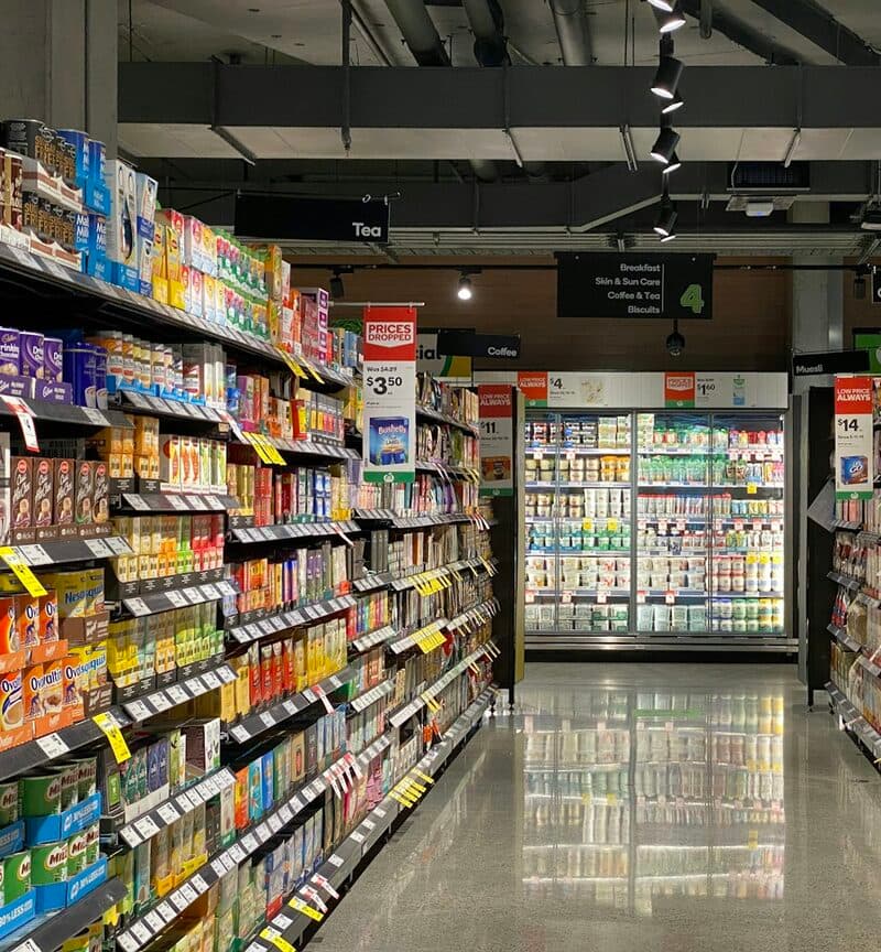A supermarket aisle stacked with tins and packets